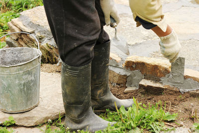 Low section of man standing on rock