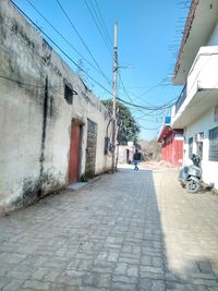 Footpath amidst buildings in city