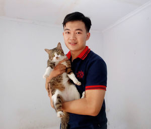 Portrait of smiling boy with cat