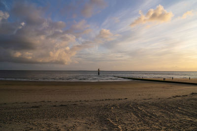 Scenic view of beach against sky during sunset