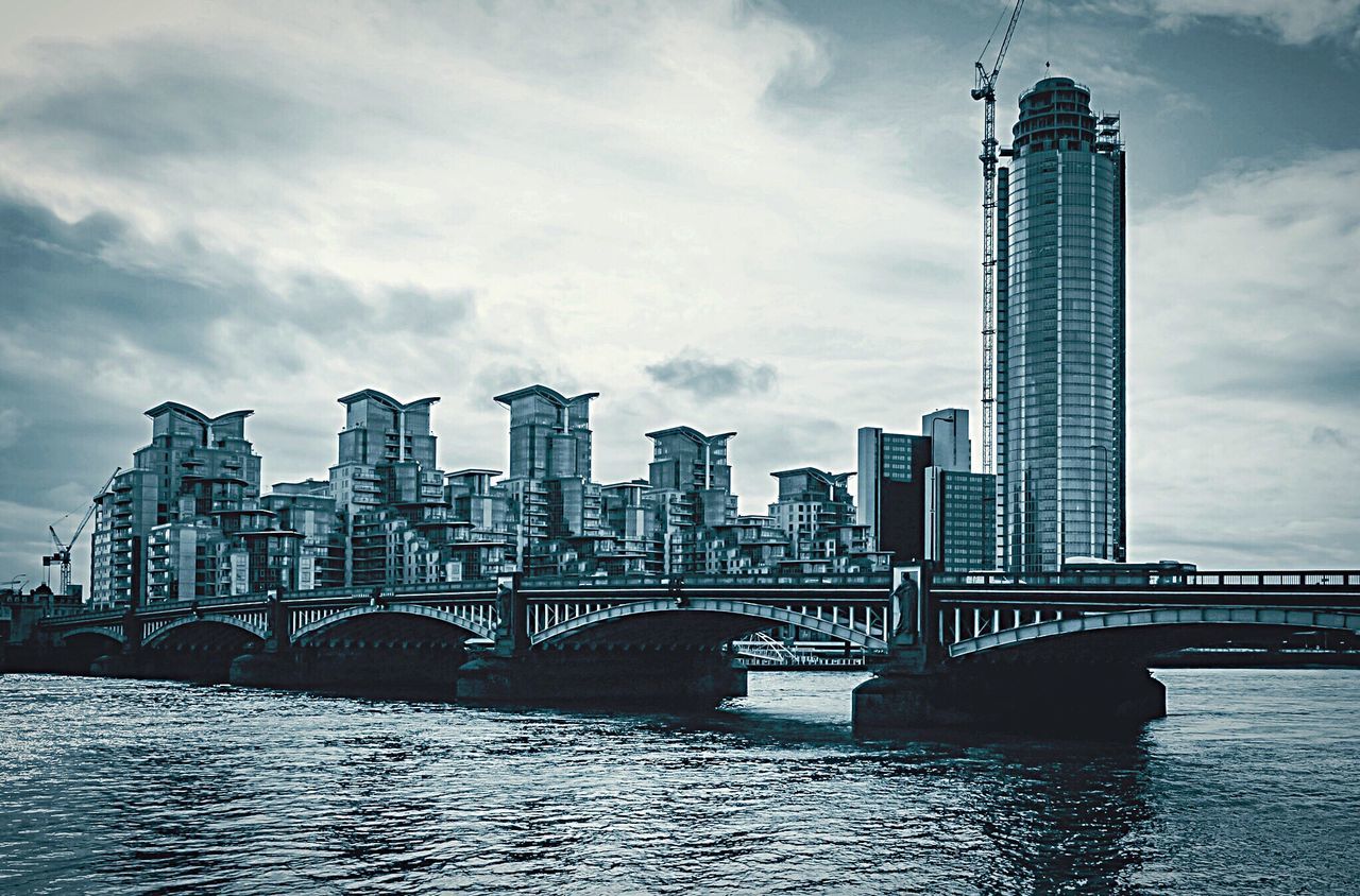 Bridge over river with city in background