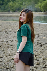 Portrait of smiling young woman standing outdoors