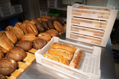 Fresh rolls of craft craft bread lies on the table in the bakery. 