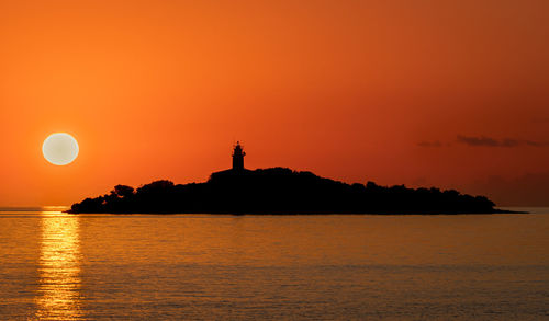 Scenic view of sea against orange sky