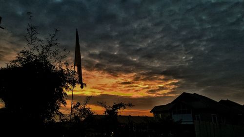 Silhouette of tree against dramatic sky