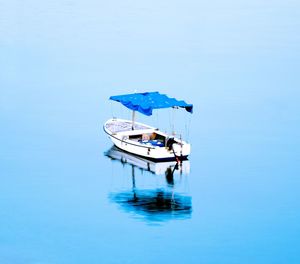 Boat sailing in sea against sky