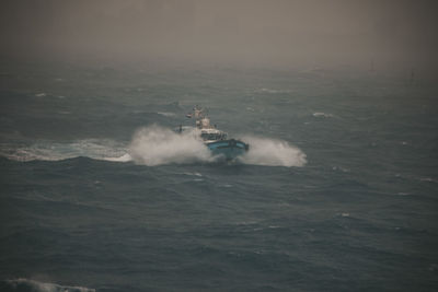 Boat sailing in sea against sky