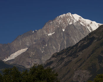 Scenic view of mountains against clear blue sky