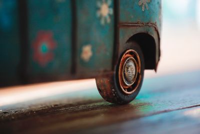 Close-up of rusty toy car on wooden table