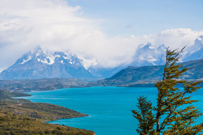 Scenic view of sea and mountains against sky