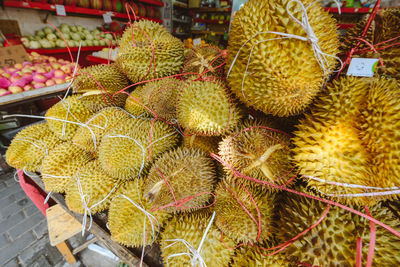 Close-up of durians for sale at market stall