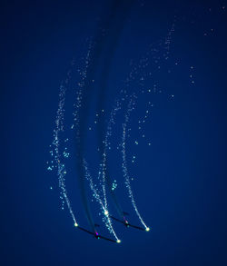 Low angle view of fireworks in sky at night