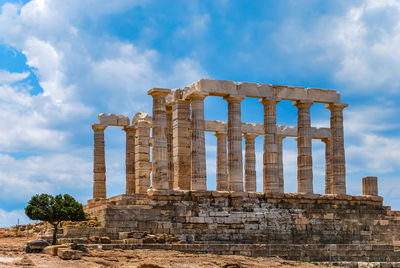 Old ruins of temple against cloudy sky