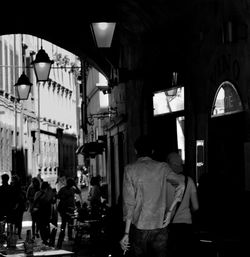 People walking in front of building at night