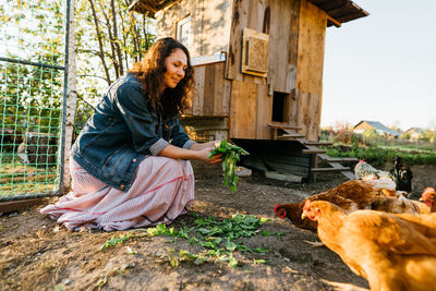 Portrait of young woman sitting on field