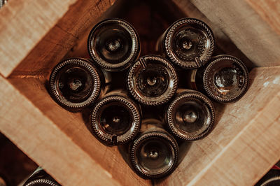 Dark wooden storage cabinet for bottle with plenty of empty bottled glass