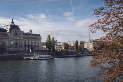 Boats in river with buildings in background