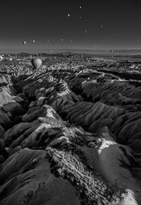 Scenic view of dramatic landscape with hot air balloon at cappadocia