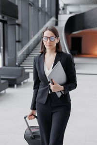 Portrait of young businesswoman using mobile phone