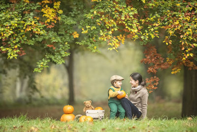 Mother and son on field during autumn