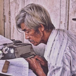 Close-up of a mid adult man holding umbrella