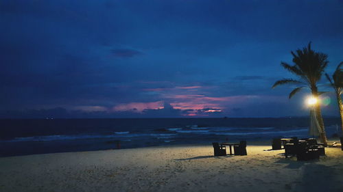 Scenic view of beach against sky at dusk