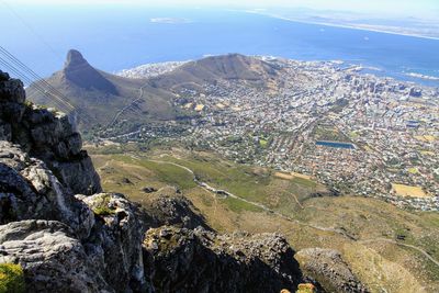 High angle view of cityscape and mountains against sky