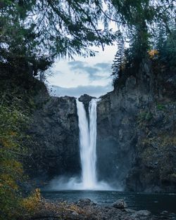 Scenic view of waterfall against trees