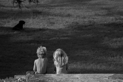 Children looking at dog