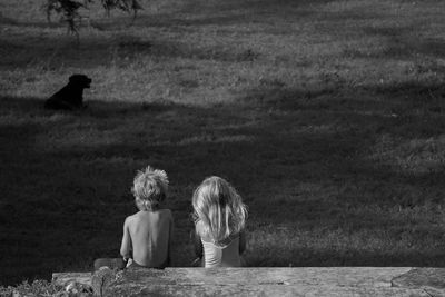 Children looking at dog