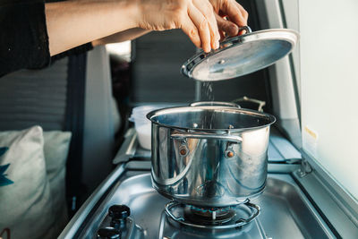 Midsection of man preparing food in kitchen at home