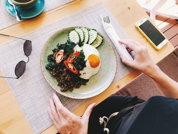 High angle view of woman holding breakfast