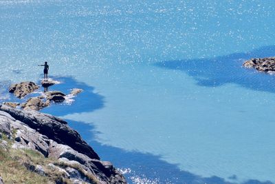 High angle view of rocks in sea against sky