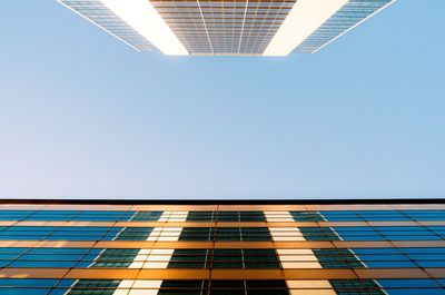 Low angle view of modern building against clear blue sky