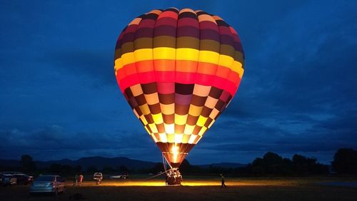 Hot air balloons flying against sky at dusk