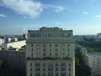 Buildings against cloudy sky