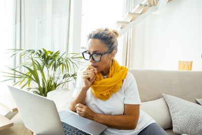 Young woman using laptop at home