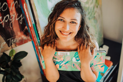 Close up of female artist and her art, canvas, paintings in studio