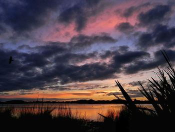 Scenic view of lake against cloudy sky