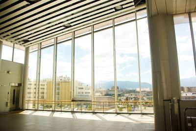 Buildings against sky seen through glass window