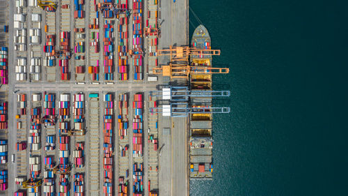 Aerial view of multi colored cargo container by lake