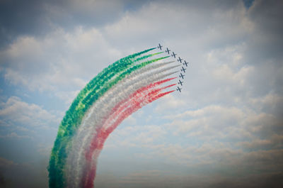 Low angle view of airshow against sky