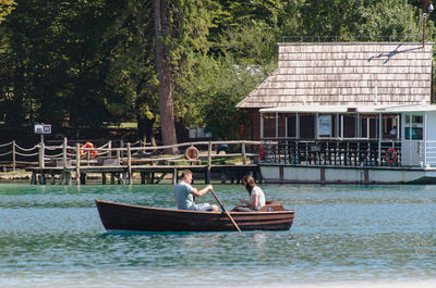 People on boat against building