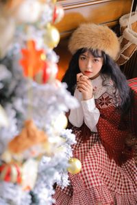 Portrait of young woman in park during winter