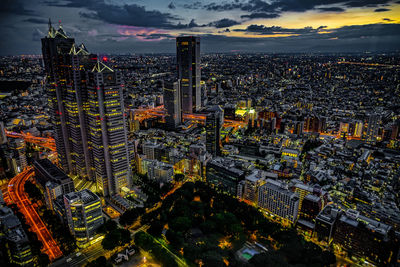 High angle view of city lit up at night