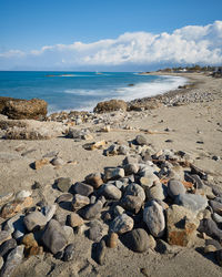 Rocks on beach against sky