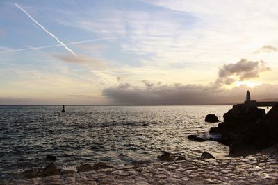 Scenic view of sea against sky at sunset