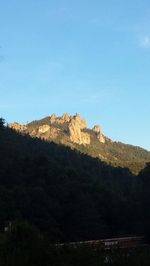 Scenic view of mountains against clear blue sky