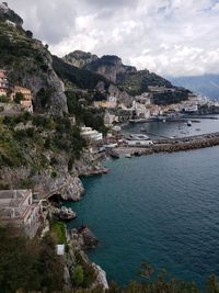 High angle view of townscape by sea against sky