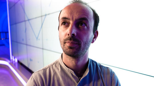 Close-up portrait of man against white background